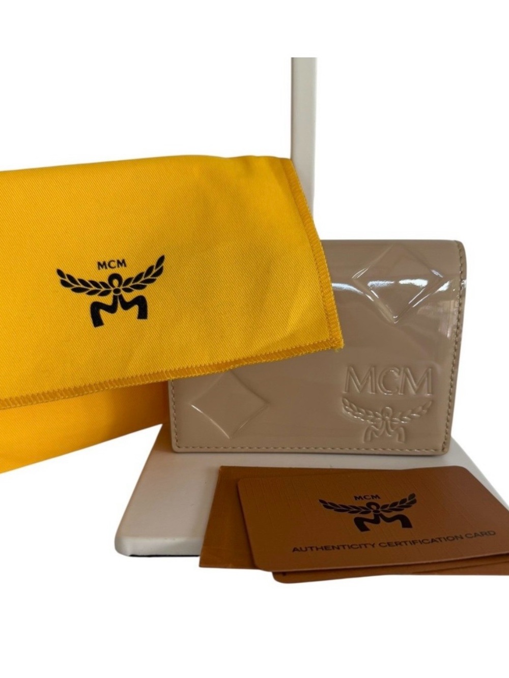 MCM NWOT Mini Patent Leather
Wallet Beige Embossed Logo
Coin Card/Holder & dusty